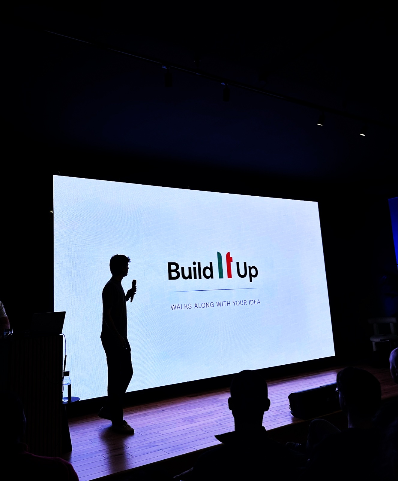 Speaker on stage at the Automation Hackathon